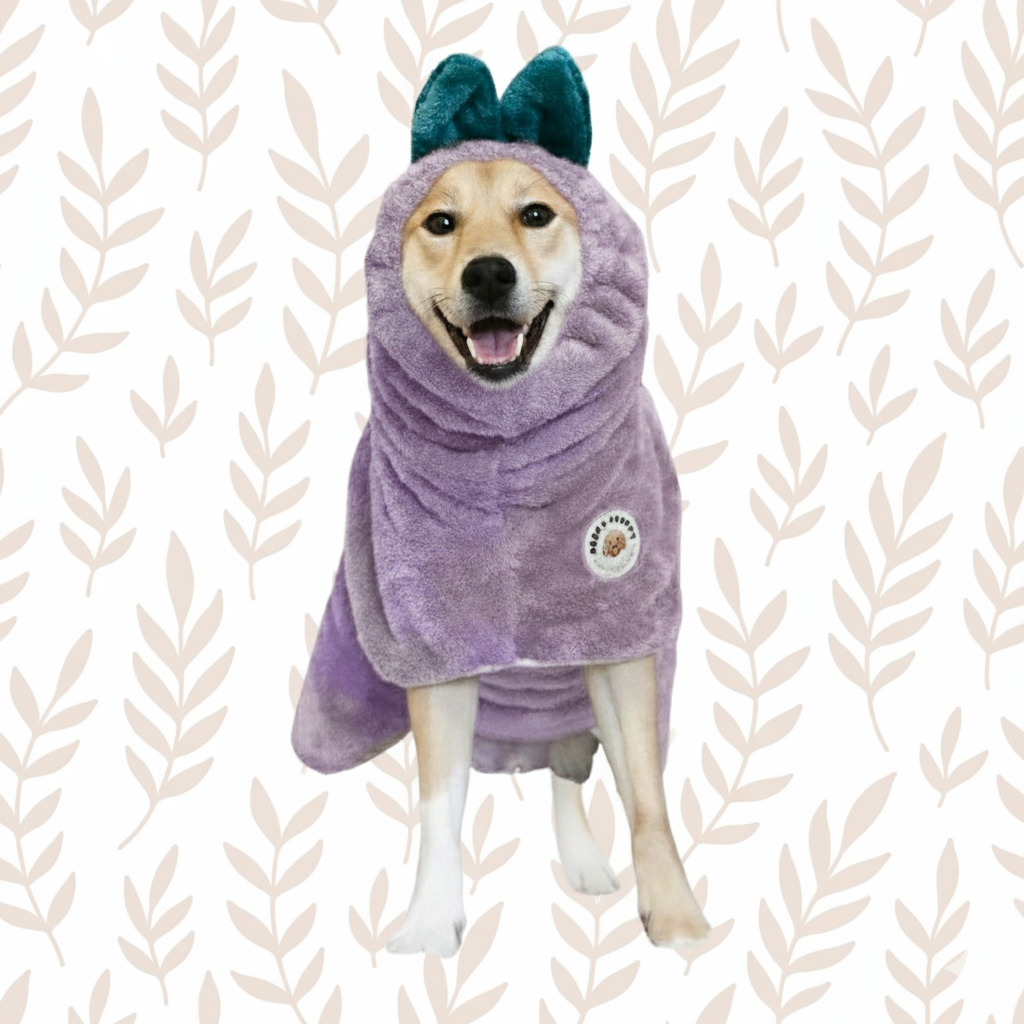 Dog wearing a lavender bathrobe with leafy ears on a leaf-patterned background